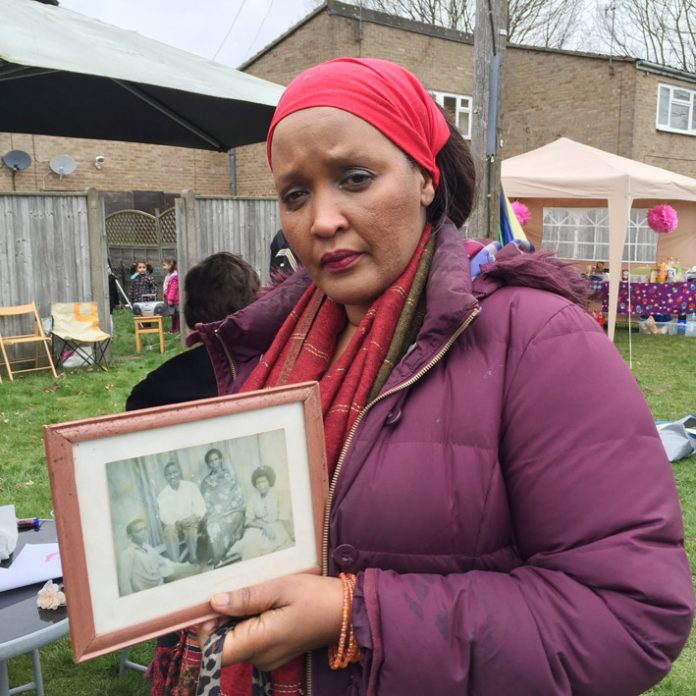 ENID MUTESI was evicted last Wednesday – shown holding a framed picture of her parents which she found in the bin