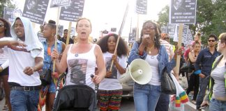 CAROL DUGGAN (centre) with MARCIA RIGG (right) marching in Tottenham
