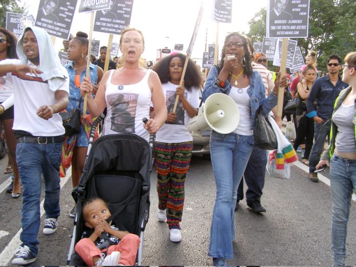 CAROL DUGGAN (centre) with MARCIA RIGG (right) marching in Tottenham