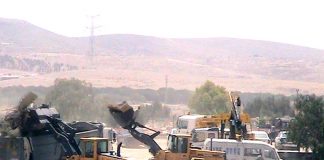 Israeli bulldozers at work demolishing the Bedouin village of al-Araqib in the Negev