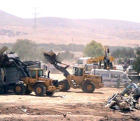 Israeli bulldozers at work demolishing the Bedouin village of al-Araqib in the Negev
