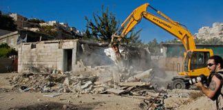 Israeli bulldozers razing the homes of Palestinians