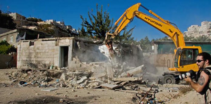 Israeli bulldozers razing the homes of Palestinians