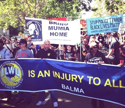The Oakland May Day march against police brutality and killings which has come together with trade unions . Workers are fighting for their rights