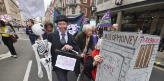 Marchers on a TUC demonstration against austerity demand jail for the bankers