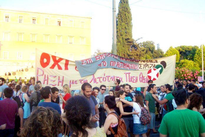 Part of Monday’s rally outside the Vouli. The SYRIZA youth banner at the rally states ‘overthrow austerity by all means’