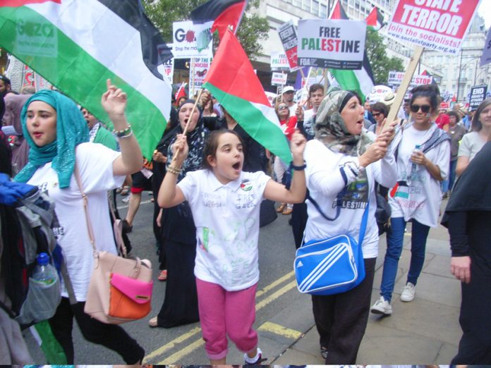 Young people marching to the Israeli Embassy in London to denounce Israeli war crimes in Gaza