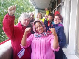 Aminata Sellu (centre) celebrates with supporters after successfully barring the way to bailiffs and the police