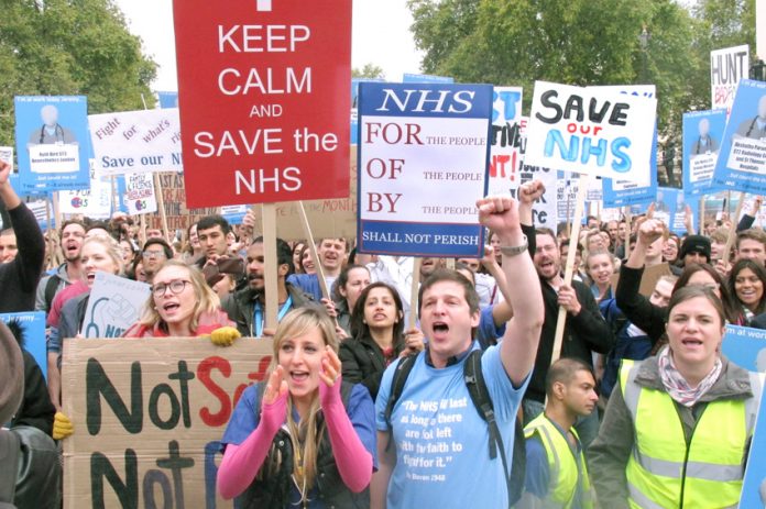 Some of the 20,000 Junior Doctors rallying in central London on Saturday display their defiance in the face of Health Secretary Hunt’s attack on their contract