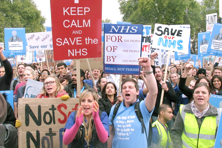Some of the 20,000 Junior Doctors rallying in central London on Saturday display their defiance in the face of Health Secretary Hunt’s attack on their contract