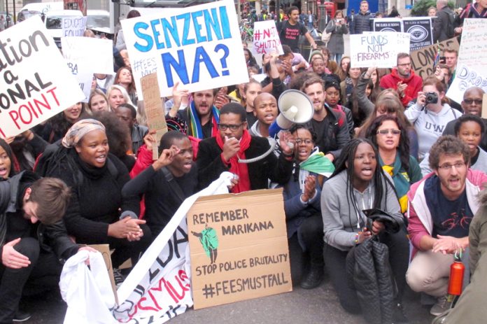 South African students in a sit-down protest outside the South African embassy demanded an end to police brutality against protesting students in South Africa