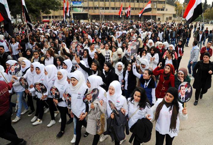 Syrian schoolgirls show their support for President Assad on Army Day