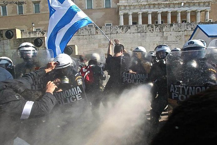 Greek farmers attacked by riot police while protesting against a massive attack on pensions imposed on Greece by the European Union Photo credit: Marios Lolos