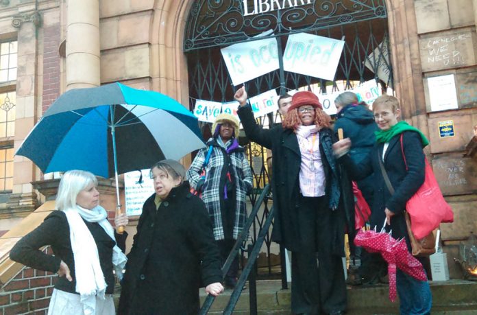 Supporters of the Carnegie Library in Lambeth gather outside on Saturday night in support of the round-the-clock occupation inside the building