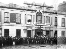 The Irish Citizens Army on parade outside Liberty Hall with their famous ‘We serve neither King nor Kaiser’ banner