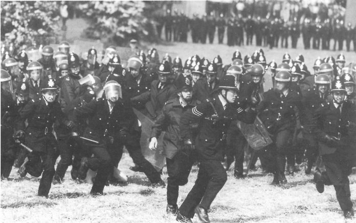 Ranks of police charge striking miners at Orgreave in 1984