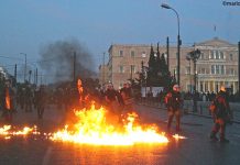 Greek riot police on Sunday night attacked protesters, who fought back with petrol bombs in scenes which resembled a war zone. Photo credit: MARIOS LOLOS