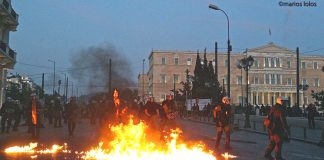 Greek riot police on Sunday night attacked protesters, who fought back with petrol bombs in scenes which resembled a war zone. Photo credit: MARIOS LOLOS