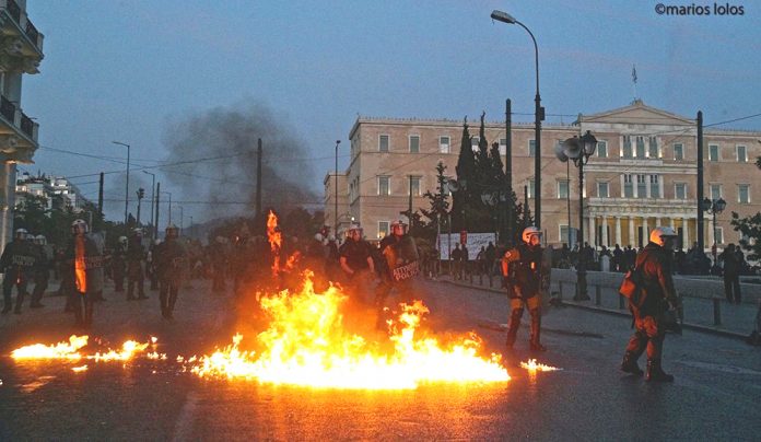 Greek riot police on Sunday night attacked protesters, who fought back with petrol bombs in scenes which resembled a war zone. Photo credit: MARIOS LOLOS