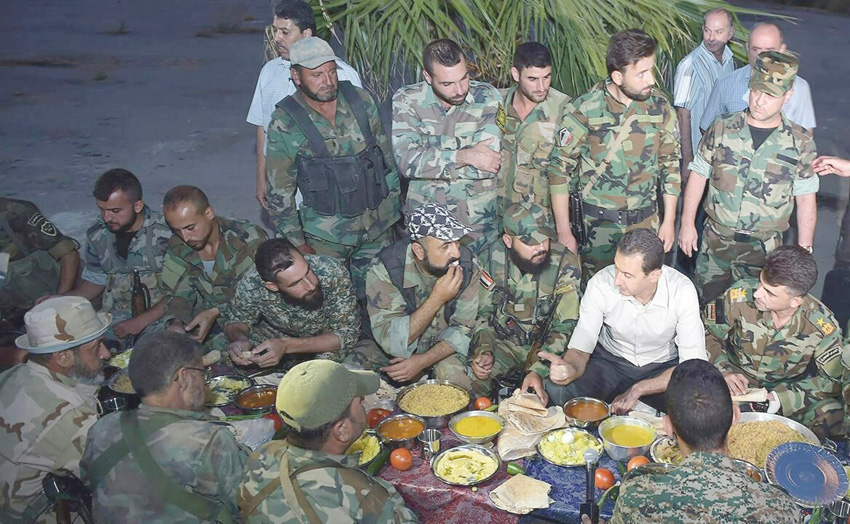 Syrian President Assad shares a meal with the troops of the Syrian army