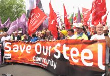 Steel workers march past parliament in May demanding action to save the steel industry