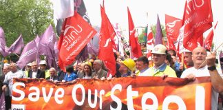 Steel workers march past parliament in May demanding action to save the steel industry