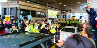 British police working with the French government taking action to stop a convoy boarding a ferry going to Calais