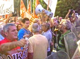 Workers confronting armed riot police at the entrance to the Thessaloniki International Trade Fair