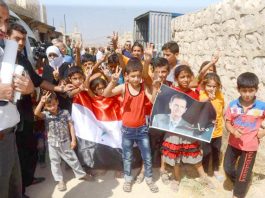 Families in east Aleppo show their support for President Assad
