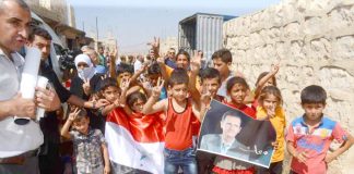 Families in east Aleppo show their support for President Assad