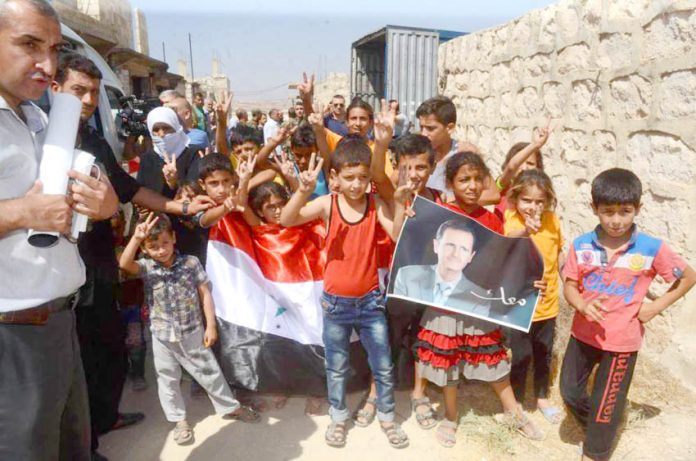 Families in east Aleppo show their support for President Assad