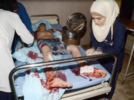 Syrian hospital workers treat a boy injured during a terrorist attack in Aleppo