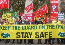 RMT president SEAN HOYLE, assistant general secretary STEVE HEDLEY and general secretary MICK CASH (all behind the banner from the front, left) on the union’s 300-strong protest opposite parliament against driver-only trains