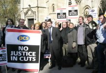 PCS leader MARK SERWOTKA (centre) at a rally against cuts