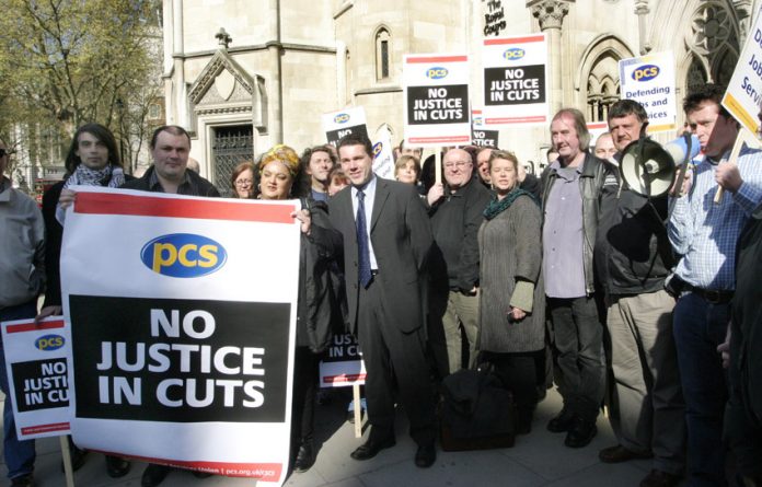 PCS leader MARK SERWOTKA (centre) at a rally against cuts