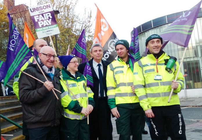 NHS ambulance workers picket their London HQ over wages and jobs