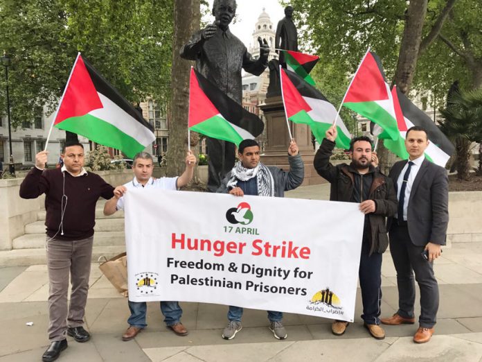 AYSAR SHAMALLAKH (left) launching his hunger strike at 6.00pm on Tuesday 2nd May in Parliament Square under the statue of Nelson Mandela in solidarity with 1,600 Palestinian prisoners of Israel