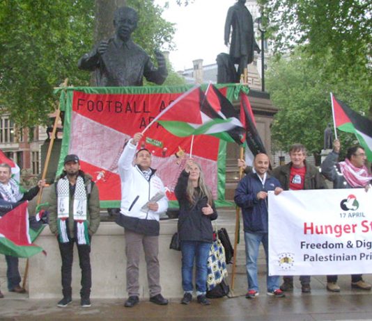 Palestinian AYSAR SHAMALLAKH (centre in white jacket) on hunger strike in solidarity with over 1,600 hunger-striking Palestinian prisoners in Israeli jails. Picture shows Aysar and supporters demonstrating in Parliament Square on Wednesday evening