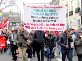 The Workers Revolutionary Party banner on the march to defend the NHS leading the fight to stop NHS privatisation and to smash the STP programme