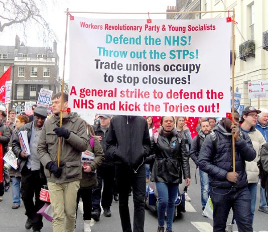 The Workers Revolutionary Party banner on the march to defend the NHS leading the fight to stop NHS privatisation and to smash the STP programme