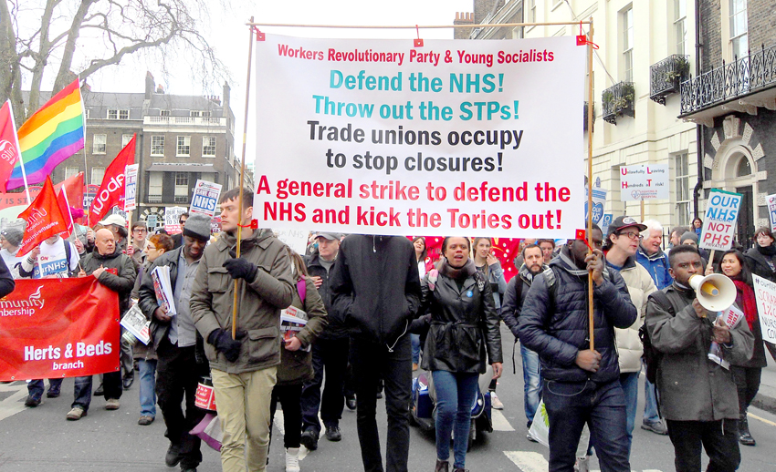 The Workers Revolutionary Party banner on the march to defend the NHS leading the fight to stop NHS privatisation and to smash the STP programme