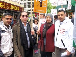 ‘From The River To The Sea Palestine Will Be Free’ Palestinian footballer MAHMOUD SARSAK (left) with London Palestinian hunger striker AYSAR SHAMALLAKH (right) and his wife