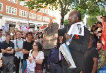 At a rally last Friday at the Department for Communities and Local Government a resident from north Kensington holds up a piece of charred cladding that had fallen from Grenfell Tower during the blaze