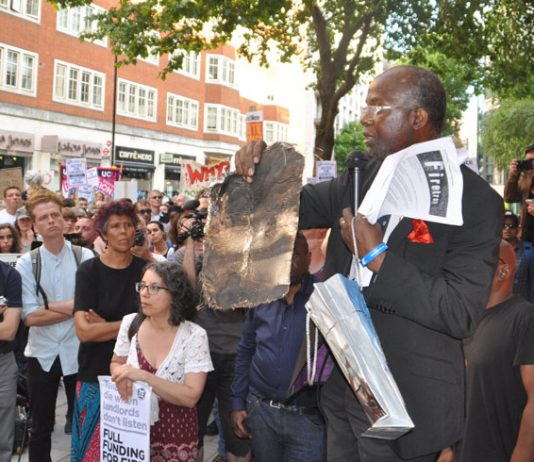 At a rally last Friday at the Department for Communities and Local Government a resident from north Kensington holds up a piece of charred cladding that had fallen from Grenfell Tower during the blaze