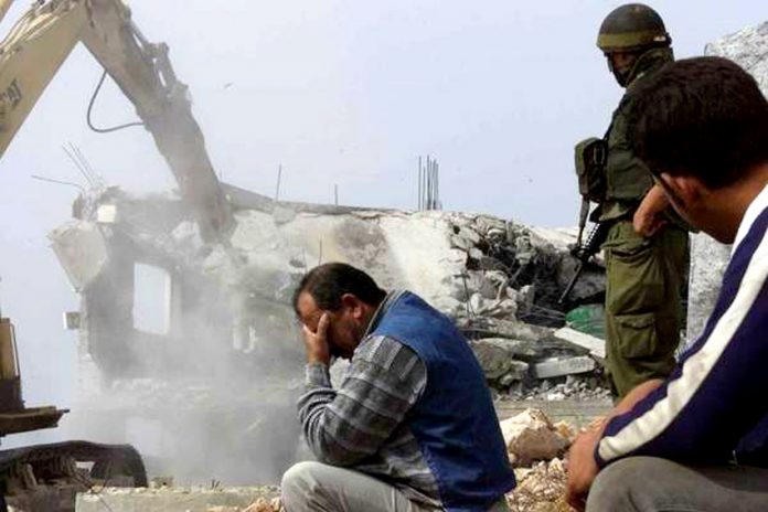 A Palestinian man in despair while his home is being demolished by the Israeli army as ‘collective punishment’