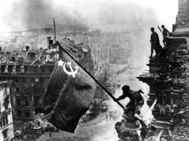 A Red Army soldier raises the Hammer and Sickle above the Reichstag, completing its liberation of Eastern Europe
