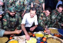 Syrian President Assad breaks his fast during Ramadan with Syrian troops