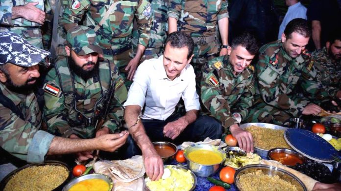 Syrian President Assad breaks his fast during Ramadan with Syrian troops