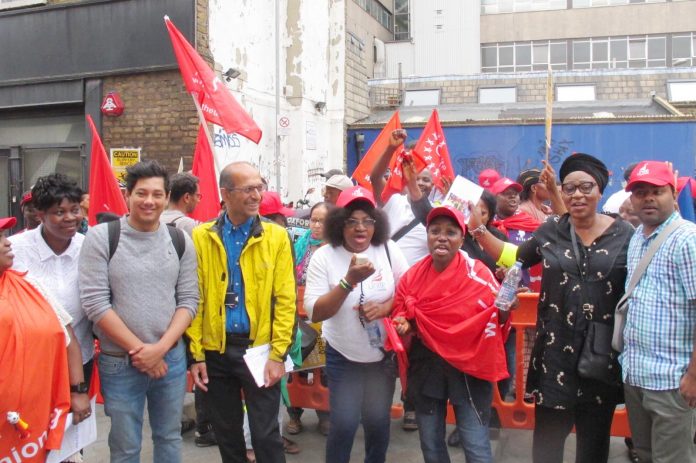 Junior doctors leader JEEVES WIJESURIYA (2nd left) joins SERCO strikers yesterday on the picket line at the Royal London Hospital