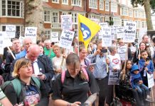 Crowds assemble outside the Kensington Council meeting where Grenfell Tower survivors told the councillors to resign